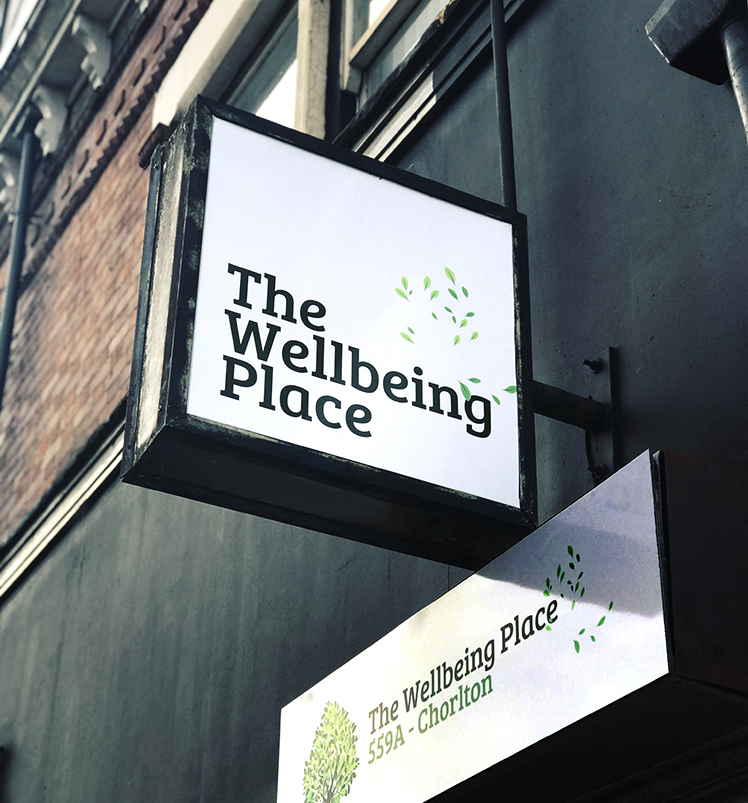 The Wellbeing Place sign on Wilbraham Road, Chorlton